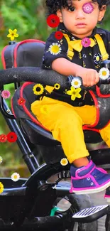 Child on tricycle with colorful flower background.