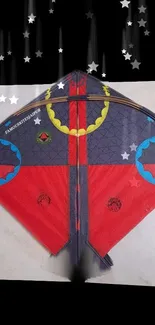 Vibrant kite design with red, blue, and yellow colors on a dark background.