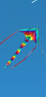 Colorful kite soaring in a clear blue sky.