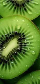 Bright green kiwi slice wallpaper with water droplets on a mobile screen.