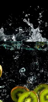 Kiwi slices splashing into water with bubbles on a black background.
