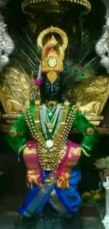 Vibrant Krishna temple artwork with green attire and ornate jewelry.