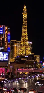 Las Vegas Strip with Eiffel Tower at night, glowing in vibrant neon lights.