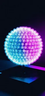 Vibrant LED globe with pink and blue hues glowing in the dark.