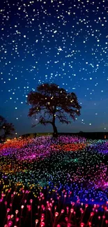 Lone tree in illuminated, colorful LED night meadow.