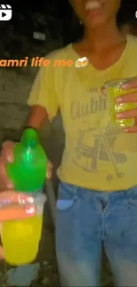 Person holding green drink at fun gathering.