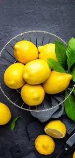 Bright yellow lemons on dark slate background.