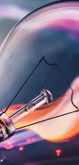 Vibrant light bulb with colorful abstract background.