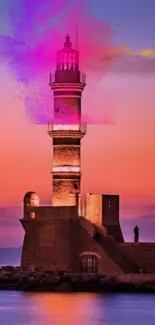 Lighthouse with vibrant pink sunset sky.