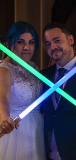 Couple with lightsabers at wedding celebration.