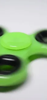 Lime green fidget spinner on white background.