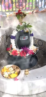 Vibrant wallpaper of Shiva Lingam altar decorated with flowers and offerings.