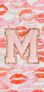 Lip print and letter M wallpaper in pink and coral hues.