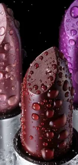 Three lipsticks with water droplets on black background.