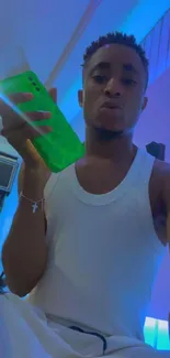 Stylish individual holding a green phone in modern setting.