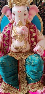 Vibrant Lord Ganesha statue in traditional attire, with pink and teal accents.