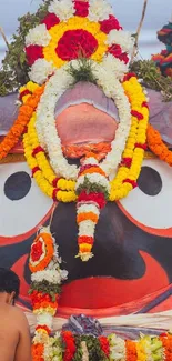 Vibrant Lord Ganesha decoration with flowers and bright colors.