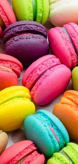 Vibrant, colorful macarons in various bright hues on a phone wallpaper.