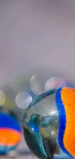 Close-up of vibrant marbles with orange and blue streaks.