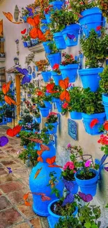 Mediterranean alley with blue flower pots and vibrant street scene.