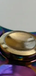 Colorful metal spinner with gold center.