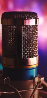 Artistic close-up of a microphone with a vibrant magenta bokeh background.