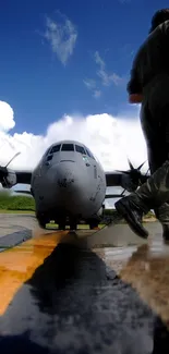 Military aircraft on runway with a soldier and vivid cloudy sky backdrop.