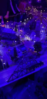 Miniature cityscape at night with vibrant blue hues and lights.