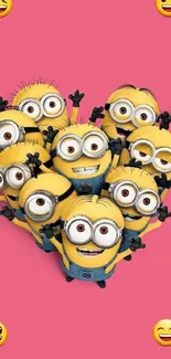 Minions forming a heart shape on a pink background with smiling faces.