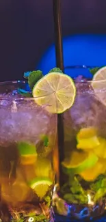 Two mojitos with lime and mint garnish on a decorative background.