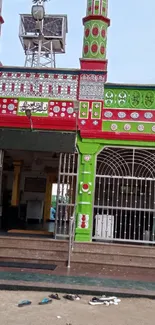 Vibrant green mosque exterior with intricate patterns.