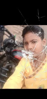 Boy in yellow outfit beside black motorcycle.