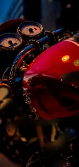 Close-up of a vintage motorcycle with a vivid red fuel tank and chrome details.