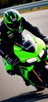 Motorcyclist in vibrant green gear racing on track.