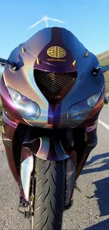 Vibrant sports bike on a scenic roadway under a clear blue sky.