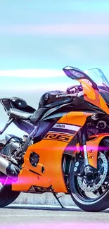 Orange motorcycle with dynamic colors on mobile wallpaper.