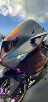 Sleek purple motorcycle against a cloudy sky.