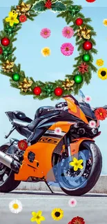 Orange motorcycle adorned with a green festive wreath against a blue sky.