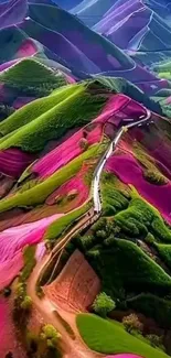 A vibrant aerial view of colorful green and pink mountains.