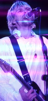 Musician passionately playing guitar on stage under purple lights.