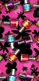 Colorful nail polish on pink floral background wallpaper.