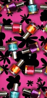 Vibrant nail polish bottles on pink floral wallpaper.