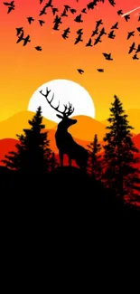 A silhouetted deer against a vivid sunset with birds and trees.