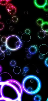 Vibrant neon bubble wallpaper with colorful circles on black background.