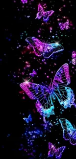 Vibrant neon butterflies on a black background wallpaper.