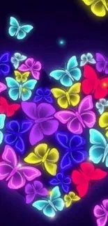 Vibrant neon butterflies forming a heart shape on a dark blue background.