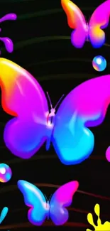 Vibrant neon butterflies on black background wallpaper.