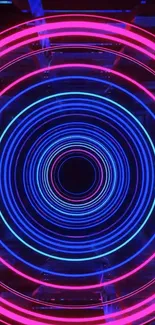 Neon concentric circles in pink and blue colors on a dark background.