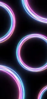 Mobile wallpaper with vibrant neon circles glowing in pink and blue hues on a black background.