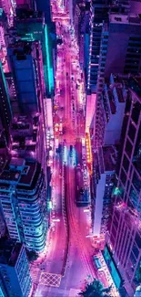 Aerial view of neon-lit city streets at night.